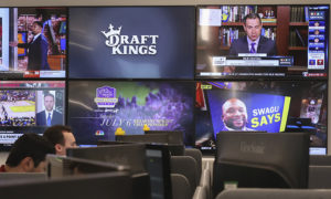 DraftKings logo on television in office with cubicles