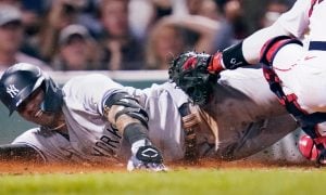 New York Yankees Gleyber Torres slides for a story on a Caesars sports betting offer for the Boston Red Sox game.