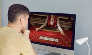 man playing blackjack on computer