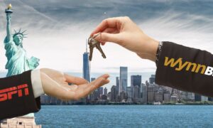 arm with wynnbet logo hands keys to arm with espn logo nyc in background