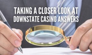 man looking through magnifying glass at stack of papers