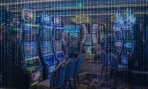 image of cybersecurity code over video lottery machines, much like those that were impacted by a cyberattack at New York casinos