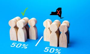 Wooden people on blue screen with 50% under each group for story on gambling exec saying new ny online casino bill has less than 50% odds