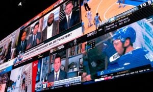 Video screens at a sportsbook for a story on bills to restricts language used in New York sports betting bonuses