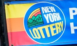 Image of a sign for the New York Lottery, which announced a renewed contract with Scientific Games for instant scratch-offs.
