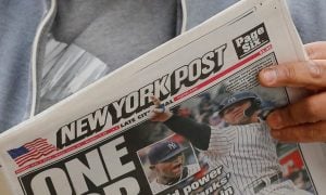 Man reads the New York Post for a story on an op-ed that urges Gov. Kathy Hochul not to expedite the downstate NY casino licensing process.