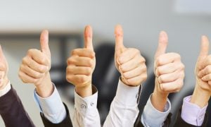Image of hands giving the thumbs up for a story on state regulators supporting a bill to speed up the downstate New York casino licensing process.