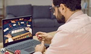Image of a man playing poker online for a story on an Ohio report suggesting that's the best path to take before online casinos.