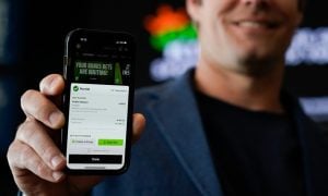 Image of DraftKings Sportsbook on a phone for a story on DraftKings deciding not to implement a surcharge on winning bets for New York sports betting users.
