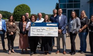 Guests' leftover chips, vouchers, and cash added up to a $9,000 check for Caring Together, a Capital Region ovarian cancer support group.